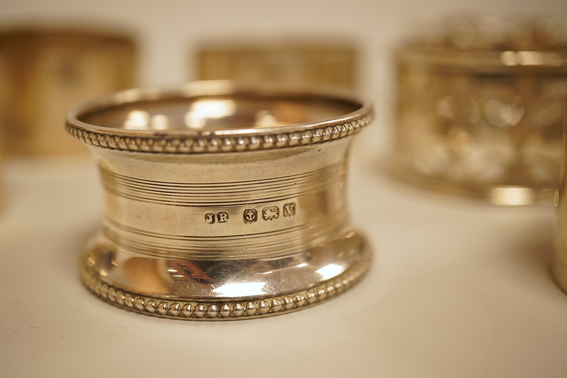 A pair of Edwardian pieced silver napkin rings by Henry Wigfull, Sheffield, 1905, together with nine other assorted silver napkin rings.